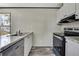 Well-lit kitchen featuring stainless steel appliances, granite countertops, and wood-look flooring at 16137 Melbourne St, Brooksville, FL 34604