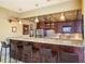 A stylish bar area with granite countertops, barstools, and stainless steel appliances at 1621 Gulf Blvd # 1604, Clearwater Beach, FL 33767