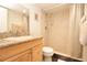 Updated bathroom features a granite countertop, wood vanity, and a walk-in shower at 1621 Gulf Blvd # 1604, Clearwater Beach, FL 33767