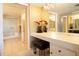 Well-lit bathroom with a vanity area, large mirror, and a separate toilet and shower room at 1621 Gulf Blvd # 1604, Clearwater Beach, FL 33767