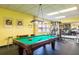Active game room featuring a pool table, exercise equipment, and natural light for entertaining and recreation at 1621 Gulf Blvd # 1604, Clearwater Beach, FL 33767
