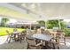 Outdoor patio with multiple tables, chairs, and barbecue grills for relaxed outdoor dining at 1621 Gulf Blvd # 1604, Clearwater Beach, FL 33767