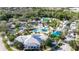 Amazing aerial view of the community pool, playground, and clubhouse nestled among lush trees at 16516 Bridgewalk Dr, Lithia, FL 33547