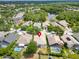 Overhead view of a home showcasing a screened lanai in a peaceful neighborhood near a scenic lake and lush landscaping at 16516 Bridgewalk Dr, Lithia, FL 33547