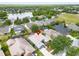 Aerial shot of the home nestled in a serene neighborhood with lake views and mature trees, marked by a location pin at 16516 Bridgewalk Dr, Lithia, FL 33547