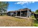 A relaxing covered lanai in backyard, perfect for outdoor living with access to a grass and landscaped yard at 16516 Bridgewalk Dr, Lithia, FL 33547