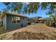 A cozy backyard featuring a screened lanai, perfect for outdoor relaxation and entertaining with views of neighboring houses at 16516 Bridgewalk Dr, Lithia, FL 33547