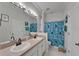 Bathroom featuring double sinks, a large mirror, and a bathtub with a shower at 16516 Bridgewalk Dr, Lithia, FL 33547