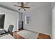 Comfortable bedroom with hardwood floors, a ceiling fan, and a gray accent wall at 16516 Bridgewalk Dr, Lithia, FL 33547