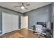 This bedroom features hardwood floors, a ceiling fan, and a closet with a door at 16516 Bridgewalk Dr, Lithia, FL 33547