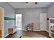 Neutral ' room with hardwood floors, a toy storage bench, a play area, and attached bathroom at 16516 Bridgewalk Dr, Lithia, FL 33547