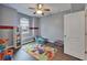 Bright, fun ' room with a ceiling fan, hardwood floors, colorful accents and -size furniture at 16516 Bridgewalk Dr, Lithia, FL 33547