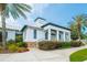 Exterior of Fishhawk Aquatic Club features a classic white facade with columns and lush landscaping for a welcoming appeal at 16516 Bridgewalk Dr, Lithia, FL 33547