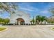 Exterior of The Palmetto Club boasting a grand entrance, complemented by manicured landscaping and a spacious driveway at 16516 Bridgewalk Dr, Lithia, FL 33547