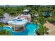 Breathtaking aerial view of community pool with grotto, rock features, and inviting turquoise water at 16516 Bridgewalk Dr, Lithia, FL 33547