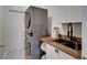 The laundry room has a stacked washer/dryer and a sink with wood countertop at 16516 Bridgewalk Dr, Lithia, FL 33547