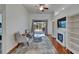 Cozy living room with a fireplace, plush seating, and sliding glass doors to the backyard at 16516 Bridgewalk Dr, Lithia, FL 33547