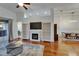 Open-concept living room featuring hardwood floors, fireplace, and built-in shelving at 16516 Bridgewalk Dr, Lithia, FL 33547