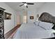 Bright and spacious main bedroom with a ceiling fan, wooden floors, and adjacent bathroom at 16516 Bridgewalk Dr, Lithia, FL 33547