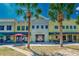Beautiful town center featuring colorful storefronts, palm trees, outdoor seating, and pedestrian walkway at 16516 Bridgewalk Dr, Lithia, FL 33547
