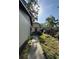 Exterior backyard view shows a home and detached garage with a red door at 1703 N Taylor Rd, Brandon, FL 33510