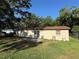 Back of home showing partial concrete patio, lawn, wood fence and siding of home at 1703 N Taylor Rd, Brandon, FL 33510
