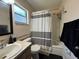 Cozy bathroom featuring a shower-tub combination and a single sink vanity at 1703 N Taylor Rd, Brandon, FL 33510