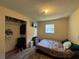 Simple bedroom with a bed, television, closet, and laminate flooring at 1703 N Taylor Rd, Brandon, FL 33510
