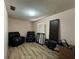 Spacious bedroom featuring laminate flooring, two recliners and natural light at 1703 N Taylor Rd, Brandon, FL 33510