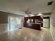Open-concept dining area connecting to the kitchen with a ceiling fan and sliding door at 1703 N Taylor Rd, Brandon, FL 33510