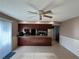 Bright dining area with tile flooring and a ceiling fan, leading to the kitchen at 1703 N Taylor Rd, Brandon, FL 33510