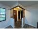 Charming entryway showcasing a dark wood front door, stone flooring, and decorative latticework at 1703 N Taylor Rd, Brandon, FL 33510