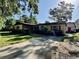 Charming single-story home with mature trees, a long driveway, and lush landscaping at 1703 N Taylor Rd, Brandon, FL 33510