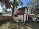Exterior shot of a detached garage with tan siding and a red door at 1703 N Taylor Rd, Brandon, FL 33510
