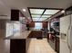 Well-equipped kitchen featuring granite countertops, stainless steel appliances, and dark wood cabinetry at 1703 N Taylor Rd, Brandon, FL 33510