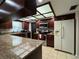 Stylish kitchen with granite countertops, stainless steel appliances, and dark wood cabinetry at 1703 N Taylor Rd, Brandon, FL 33510