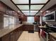 Bright kitchen featuring stainless steel appliances, granite countertops, and custom cabinetry at 1703 N Taylor Rd, Brandon, FL 33510