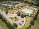Aerial view of community pool and recreation area featuring ample lounge chairs and parking at 19047 Alfaro Loop, Spring Hill, FL 34610