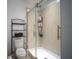 Well-lit bathroom featuring tiled shower with glass door and modern fixtures at 19047 Alfaro Loop, Spring Hill, FL 34610