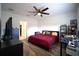Cozy bedroom with ceiling fan, neutral walls, and wood-look flooring at 19047 Alfaro Loop, Spring Hill, FL 34610