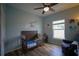 Charming Bedroom with crib, accent chair, and calming blue walls at 19047 Alfaro Loop, Spring Hill, FL 34610