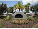Talavera community entrance sign surrounded by palm trees, flowers and lush greenery at 19047 Alfaro Loop, Spring Hill, FL 34610