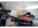 Open-concept living space with kitchen island, dining area, and comfortable living room furniture at 19047 Alfaro Loop, Spring Hill, FL 34610