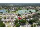 An aerial view of a well-situated home within a residential neighborhood with a nearby lake at 1910 Elk Spring Dr, Brandon, FL 33511