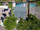 Aerial view of a home showcasing the backyard pool, solar panels, and the lush greenery surrounding the property at 1910 Elk Spring Dr, Brandon, FL 33511