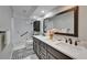 An updated bathroom featuring a double vanity, modern fixtures, and a tiled shower with glass door at 1910 Elk Spring Dr, Brandon, FL 33511