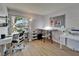 A bright craft room features a large window, a sewing machine, and ample workspace for creative projects at 1910 Elk Spring Dr, Brandon, FL 33511