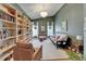Inviting living room featuring a custom bookshelf, high ceilings, and natural light at 1910 Elk Spring Dr, Brandon, FL 33511