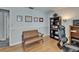 A bright home office space with hardwood floors, a desk, shelving, and a comfortable sitting area at 1910 Elk Spring Dr, Brandon, FL 33511