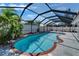 Relaxing screened-in pool surrounded by lush greenery, creating a private and serene outdoor oasis at 1910 Elk Spring Dr, Brandon, FL 33511